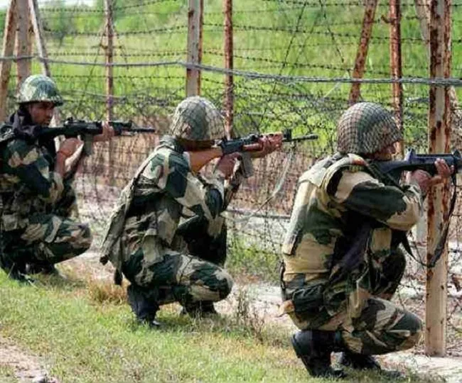 Indian Border Security Force personnel in position along the border fence
