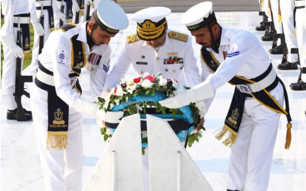 Pakistan Navy officers lay a wreath at a memorial ceremony honouring fallen sailors