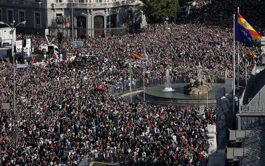 Tens of thousands of protesters fill Madrid's Plaza de Cibeles during a mass march in Spain