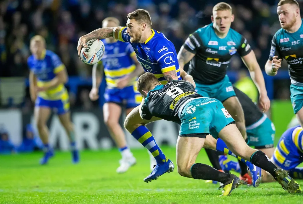 Warrington Wolves ball-carrier tackled by a Leeds Rhinos defender in the Super League semi-final