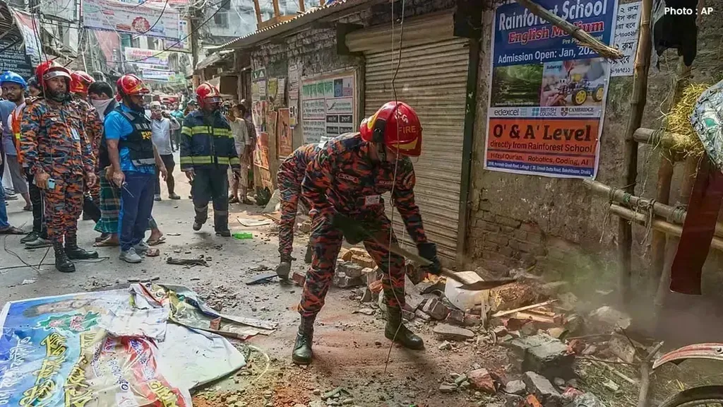 Fire and rescue workers clear rubble on a Dhaka street after earthquakes struck Bangladesh