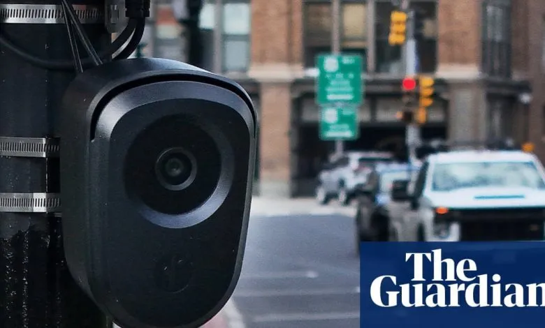 A Flock Safety license-plate camera mounted on a pole at a city intersection