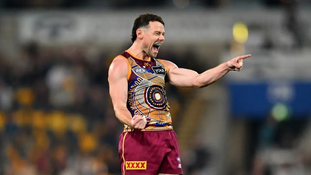 Brisbane Lions AFL star Lachie Neale celebrates during a match in the Indigenous-round guernsey
