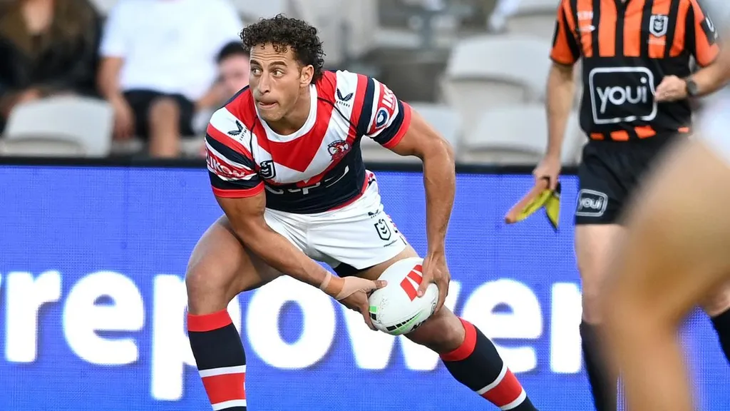 A Sydney Roosters player charges with the ball in NRL action