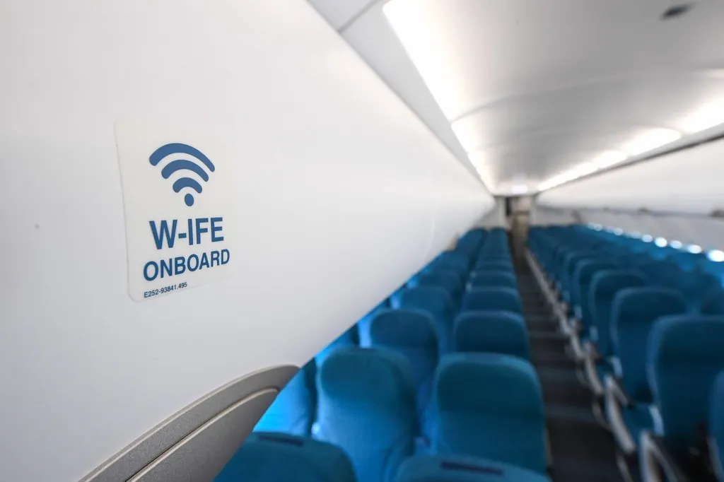 A wireless in-flight entertainment Wi-Fi sign inside an airliner cabin